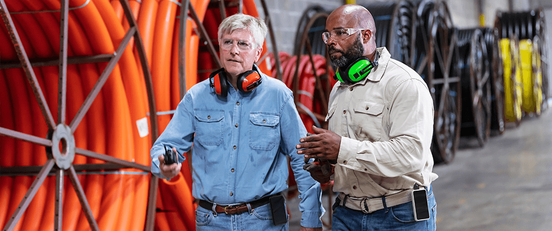 Factory workers wearing Sense Badge